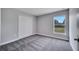 Neutral bedroom with carpeted floors, closet, and natural light streaming through a window with lush outdoor views at 547 Viceroy Ct, Kissimmee, FL 34758