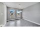 Spacious dining area with a modern chandelier, tile floors, and large windows at 547 Viceroy Ct, Kissimmee, FL 34758