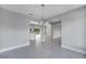 Open-concept dining area with gray tile floors and a view of the modern kitchen at 547 Viceroy Ct, Kissimmee, FL 34758