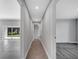 Bright hallway featuring tile flooring that transitions to carpeted bedrooms and leading to an airy living space at 547 Viceroy Ct, Kissimmee, FL 34758