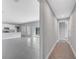Hallway view of open concept floor plan features a kitchen, living room, and hallway at 547 Viceroy Ct, Kissimmee, FL 34758