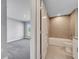 Hallway showcasing bedroom and bathroom, each featuring modern interiors, neutral color palettes, and tile/carpeted floors at 547 Viceroy Ct, Kissimmee, FL 34758
