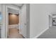 Bright hallway near a bathroom, providing entry to the bathroom with a full bathtub, tile walls, and tile floors at 547 Viceroy Ct, Kissimmee, FL 34758