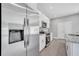 Modern kitchen boasts stainless steel appliances, granite countertops, and sleek white cabinetry at 547 Viceroy Ct, Kissimmee, FL 34758