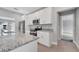 Modern kitchen features stainless steel appliances, granite countertops, and white cabinetry at 547 Viceroy Ct, Kissimmee, FL 34758