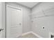 Bright laundry room with tile flooring, wire shelving, and utility connections at 547 Viceroy Ct, Kissimmee, FL 34758