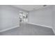 Open-concept living area with gray tile floors and neutral walls flows into the kitchen at 547 Viceroy Ct, Kissimmee, FL 34758