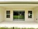Covered patio with sliding glass doors, offering indoor-outdoor living at 547 Viceroy Ct, Kissimmee, FL 34758
