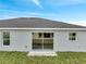 Exterior backyard view with a sliding glass door and white fence at 549 Viceroy Ct, Kissimmee, FL 34758