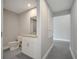 Bathroom featuring granite countertop, white cabinets and grey tiled flooring at 549 Viceroy Ct, Kissimmee, FL 34758