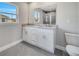 Bathroom with dual sink vanity, granite countertop, and gray tiled floor and walk-in shower at 549 Viceroy Ct, Kissimmee, FL 34758