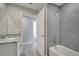 Bright bathroom with tub, tiled shower, granite vanity and grey backsplash at 549 Viceroy Ct, Kissimmee, FL 34758