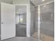 Bathroom entryway showing glass shower and bedroom with large window at 549 Viceroy Ct, Kissimmee, FL 34758