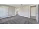 Neutral bedroom with plush carpet, white trim, and views of the attached bathroom and hallway at 549 Viceroy Ct, Kissimmee, FL 34758