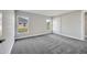 Spacious bedroom featuring soft gray walls, plush carpet, and natural light from dual windows at 549 Viceroy Ct, Kissimmee, FL 34758