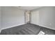 Open bedroom showing neutral walls, plush carpeting, closet, and door leading to the hallway at 549 Viceroy Ct, Kissimmee, FL 34758