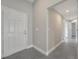 Inviting foyer with tiled flooring, white front door and neutral color scheme at 549 Viceroy Ct, Kissimmee, FL 34758