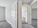 Hallway view showcasing neutral paint and plush carpeting leading to the bedroom entrance at 549 Viceroy Ct, Kissimmee, FL 34758