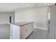 Spacious kitchen island features granite countertop with white cabinets and stainless steel refrigerator at 549 Viceroy Ct, Kissimmee, FL 34758