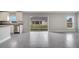 Bright living space offering backyard view via sliding glass door and kitchen featuring granite countertops at 549 Viceroy Ct, Kissimmee, FL 34758