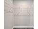 Interior of walk-in closet with white shelving and gray carpet at 549 Viceroy Ct, Kissimmee, FL 34758