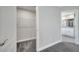 Walk-in closet with carpet flooring and wire shelving, next to a bathroom with granite countertop at 549 Viceroy Ct, Kissimmee, FL 34758