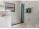 Walk-in shower featuring tile flooring, grab bar, and window for natural light at 609 Doheny Way, Casselberry, FL 32707