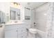All white bathroom features coordinated cabinets, backsplash, and shower curtain at 609 Doheny Way, Casselberry, FL 32707