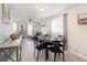 Dining area with black table and seating with easy access to the living room at 609 Doheny Way, Casselberry, FL 32707