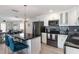 Well-appointed kitchen featuring an island with bar seating, stainless appliances, and modern gray backsplash at 609 Doheny Way, Casselberry, FL 32707