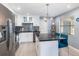 Modern kitchen featuring an island, stainless steel appliances, granite countertops, and gray tile backsplash at 609 Doheny Way, Casselberry, FL 32707