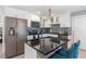 Stylish kitchen featuring an island with bar seating, stainless appliances, and granite countertops at 609 Doheny Way, Casselberry, FL 32707
