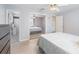 Bedroom featuring a ceiling fan, closet with mirrored doors, and view of the adjacent bathroom at 609 Doheny Way, Casselberry, FL 32707