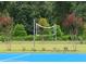 A volleyball net on the court, framed by trees, is ready for a game at 609 Doheny Way, Casselberry, FL 32707