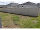 Fenced backyard with healthy lawn and view of the back of the home at 621 Vittorio Dr, Winter Haven, FL 33884