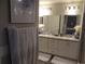 Bathroom featuring double sink vanity, large mirror, nice lighting, and modern fixtures at 621 Vittorio Dr, Winter Haven, FL 33884