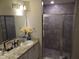 Bathroom featuring a vanity with modern fixtures and a glass-enclosed shower at 621 Vittorio Dr, Winter Haven, FL 33884