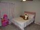 Cozy bedroom with plush pink bed and playful decor, perfect for a  at 621 Vittorio Dr, Winter Haven, FL 33884