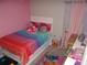Colorful bedroom with playful decor, bright bedding, and a cozy atmosphere at 621 Vittorio Dr, Winter Haven, FL 33884