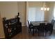 Well-lit dining area with a marble table, modern chandelier, and stylish serving bar at 621 Vittorio Dr, Winter Haven, FL 33884