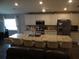 Spacious kitchen featuring stainless steel appliances, granite countertops, and a large island with seating at 621 Vittorio Dr, Winter Haven, FL 33884