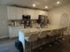 Bright kitchen featuring stainless steel appliances, countertops, and a large island with seating at 621 Vittorio Dr, Winter Haven, FL 33884