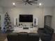 Modern living room featuring a large television, sleek entertainment center, and comfortable seating at 621 Vittorio Dr, Winter Haven, FL 33884