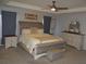 Spacious main bedroom with tray ceiling, carpet, a ceiling fan, and matching night stands and vanity at 621 Vittorio Dr, Winter Haven, FL 33884
