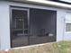Screened-in patio with chairs and view of the yard at 621 Vittorio Dr, Winter Haven, FL 33884