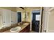 Bathroom with double sinks, spacious counter, and view of a secondary bedroom at 7110 Red Lantern Dr # 23, Harmony, FL 34773