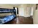 Bright bedroom with a bunk bed, dark wood floors, and a closet at 7110 Red Lantern Dr # 23, Harmony, FL 34773