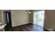Dining area featuring laminate flooring, modern chandelier and sliding glass doors at 7110 Red Lantern Dr # 23, Harmony, FL 34773