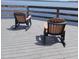 Tranquil lake view from the dock with rocking chairs at 7110 Red Lantern Dr # 23, Harmony, FL 34773