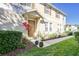 Charming townhouse with a well-maintained front yard, colorful plants, and a welcoming entryway at 7110 Red Lantern Dr # 23, Harmony, FL 34773
